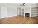 Bright living room with hardwood floors, fireplace with custom built-ins, and neutral wall colors at 7719 Barefoot Rd, Fuquay Varina, NC 27526