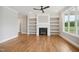 Cozy living room with hardwood floors, a gas fireplace, custom built-ins, and ample natural light at 7719 Barefoot Rd, Fuquay Varina, NC 27526