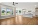 Spacious open-concept area with hardwood floors, ample natural light, and kitchen view at 7719 Barefoot Rd, Fuquay Varina, NC 27526