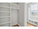 Walk-in closet with built-in shelving, window, and bench offering ample storage space at 7719 Barefoot Rd, Fuquay Varina, NC 27526