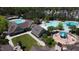 Birds eye of community amenities including pools, lounge area and play area surrounded by trees and residential housing at 78 Salt Cedar Ln, Chapel Hill, NC 27516