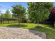 Backyard with stone patio, wrought iron fence, and mature landscaping at 78 Salt Cedar Ln, Chapel Hill, NC 27516