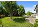 Landscaped backyard features a stone patio, beautiful trees, and a well-maintained lawn at 78 Salt Cedar Ln, Chapel Hill, NC 27516