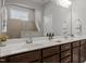 Bathroom featuring double sinks, dark cabinets, and an enclosed tile shower at 78 Salt Cedar Ln, Chapel Hill, NC 27516