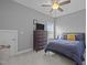 Comfortable bedroom with a blue bedspread, wooden dresser and ceiling fan at 78 Salt Cedar Ln, Chapel Hill, NC 27516