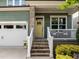 Welcoming front entrance with a charming yellow door, brick steps, and a cozy porch at 78 Salt Cedar Ln, Chapel Hill, NC 27516