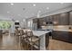Large kitchen island features pendant lighting, bar stools, and stainless steel appliances at 78 Salt Cedar Ln, Chapel Hill, NC 27516
