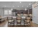 Spacious kitchen island featuring pendant lighting, barstool seating, and a view into the dining area at 78 Salt Cedar Ln, Chapel Hill, NC 27516