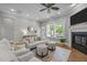 Bright, open living room with a cozy fireplace, neutral decor, and ample natural light at 78 Salt Cedar Ln, Chapel Hill, NC 27516