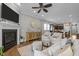 Inviting living room showcasing a fireplace, ceiling fan, and open layout connecting to the kitchen at 78 Salt Cedar Ln, Chapel Hill, NC 27516