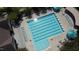 Aerial shot of a community lap pool, surrounded by chairs and umbrellas, perfect for swimming and lounging on sunny days at 78 Salt Cedar Ln, Chapel Hill, NC 27516