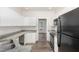 Well-lit kitchen with white cabinets, stainless appliances, and granite countertops at 7936 Milltrace, Raleigh, NC 27615