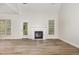 Bright living room featuring wood flooring, a fireplace, and natural light at 7936 Milltrace, Raleigh, NC 27615