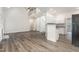 Open floor plan with staircase featuring wood flooring and leading to kitchen at 7936 Milltrace, Raleigh, NC 27615
