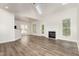 Bright living room featuring wood flooring, a fireplace, and natural light at 7936 Milltrace, Raleigh, NC 27615