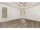 Large bedroom with wood flooring, tray ceiling, ceiling fan and ample natural light at 7936 Milltrace, Raleigh, NC 27615