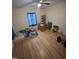 Bright bedroom featuring hardwood floors, with a ceiling fan and a cozy area for furniture or a workspace at 0 Chapel Hill Rd, Durham, NC 27707