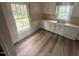 Bright kitchen featuring durable laminate flooring, ample countertop space, and natural light, ready for customization at 0 Chapel Hill Rd, Durham, NC 27707