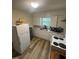 Simple kitchen with white cabinets, laminate countertops, and appliances at 0 Chapel Hill Rd, Durham, NC 27707