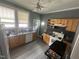 Traditional kitchen featuring wood cabinets, laminate countertops, and stainless steel sink with updated flooring at 0 Chapel Hill Rd, Durham, NC 27707