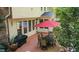 Backyard patio with a red umbrella, dining table, and grill; great for outdoor gatherings at 101 Collinson Dr, Chapel Hill, NC 27514