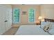 Cozy bedroom with neutral walls and carpet, with windows overlooking trees at 101 Collinson Dr, Chapel Hill, NC 27514