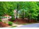 Beautiful brick home nestled among mature trees and landscaping at 101 Collinson Dr, Chapel Hill, NC 27514