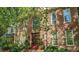 Elegant brick home with arched window and mature landscaping around the front entry at 101 Collinson Dr, Chapel Hill, NC 27514