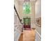 Bright foyer with high ceilings, hardwood floors, grand entry door, and a view of the upper window at 101 Collinson Dr, Chapel Hill, NC 27514