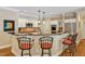 Kitchen featuring a breakfast bar with seating, modern appliances, and dark countertops at 101 Collinson Dr, Chapel Hill, NC 27514