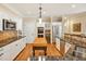 Bright kitchen boasts stainless steel appliances, granite countertops, wooden island block, and white cabinetry at 101 Collinson Dr, Chapel Hill, NC 27514