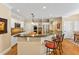 Open kitchen with bar seating, stainless appliances, granite countertops, and wooden island block at 101 Collinson Dr, Chapel Hill, NC 27514