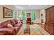 Comfortable living room featuring a plush sofa, natural light, and classic décor at 101 Collinson Dr, Chapel Hill, NC 27514