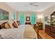 Cozy main bedroom featuring a plush bed, ceiling fan, and hardwood floors at 101 Collinson Dr, Chapel Hill, NC 27514