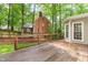 View of the back deck featuring a wooden railing overlooking the lush greenery and landscaped yard at 106 Ridgepath Way, Cary, NC 27511