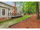 Back exterior showing a two-story house with an expansive yard, patio, deck, and ample landscaping at 106 Ridgepath Way, Cary, NC 27511