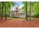 Expansive backyard featuring mature trees, lush lawn, a two-story home, and a wooden deck at 106 Ridgepath Way, Cary, NC 27511