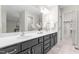 Bathroom showcases a large vanity with double sinks, and a walk-in closet providing ample storage space at 106 Ridgepath Way, Cary, NC 27511