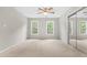 Bright bedroom with natural light from two windows, plush carpet, and a mirrored closet at 106 Ridgepath Way, Cary, NC 27511
