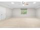 Spacious carpeted bedroom featuring a ceiling fan, recessed lighting, and double door closet at 106 Ridgepath Way, Cary, NC 27511