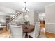 Elegant dining room with round table, seating for six, and hardwood floors at 106 Ridgepath Way, Cary, NC 27511