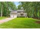 Traditional two-story home with a well-manicured lawn, mature trees, and a two-car garage at 106 Ridgepath Way, Cary, NC 27511