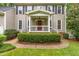 Inviting front porch with classic design details and manicured landscaping at 106 Ridgepath Way, Cary, NC 27511