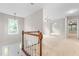 Bright hallway with a view from the staircase, featuring carpet and mirrored closet doors at 106 Ridgepath Way, Cary, NC 27511