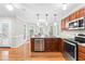 Kitchen showcasing a granite countertop island with stainless steel appliances and hardwood floors at 106 Ridgepath Way, Cary, NC 27511