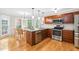 Stylish kitchen features stainless steel appliances, granite counters, and a breakfast nook with bay windows at 106 Ridgepath Way, Cary, NC 27511