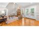 Bright living room with fireplace, hardwood floors, high ceilings, and patio access at 106 Ridgepath Way, Cary, NC 27511