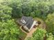 Stunning aerial view of the private estate, showcasing lush landscaping, hardscape and mature trees at 109 Henrys Ridge Rd, Pittsboro, NC 27312