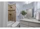 Bathroom featuring a shower-tub combo, a vanity, and soft blue walls at 109 Henrys Ridge Rd, Pittsboro, NC 27312
