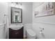 Powder room features a pedestal sink and modern toilet with wainscoting for a refined style at 109 Henrys Ridge Rd, Pittsboro, NC 27312